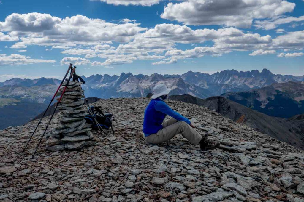 author sitting on top of a mountain